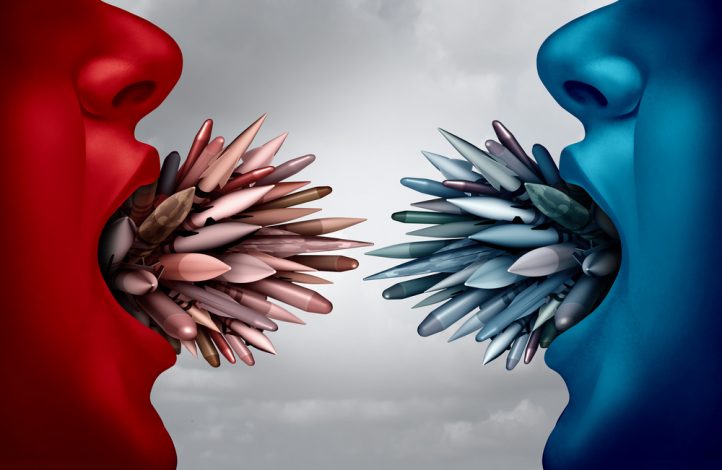 Depiction of two face profiles facing one another, one red and one blue, each with an open mouth holding numerous missiles.